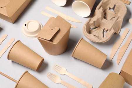Eco friendly food packaging. Paper containers and tableware on light gray backgroundの写真素材