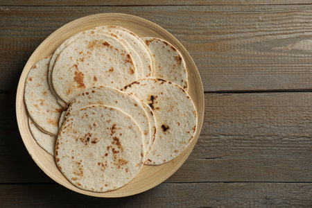 Many tasty homemade tortillas on wooden table, top viewの写真素材