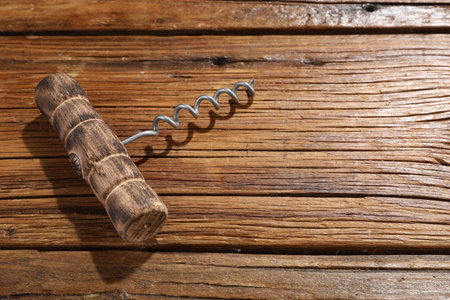 One corkscrew on wooden table, above view. Space for textの写真素材