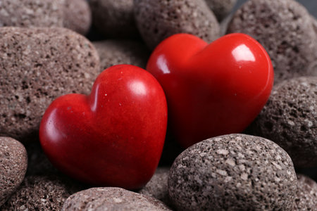Red decorative hearts on stones, closeup viewの写真素材