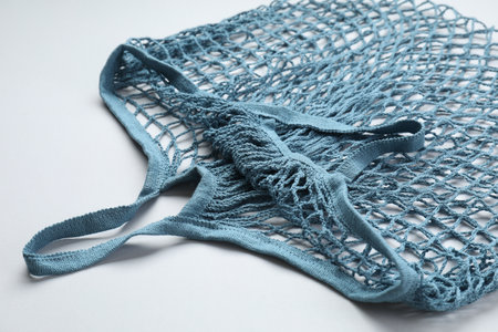 Blue string bag on light gray background, closeupの写真素材