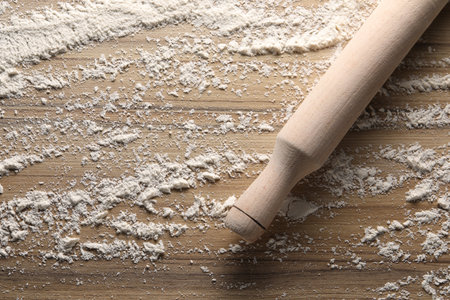 Scattered flour and rolling pin on wooden table, top viewの写真素材