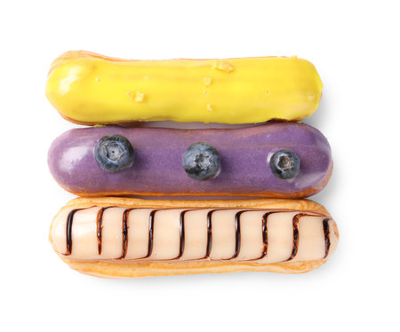 Delicious eclairs covered with glaze isolated on white, top viewの写真素材