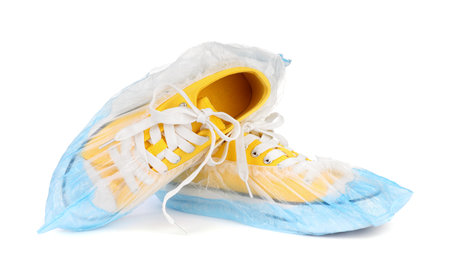 Sneakers in blue shoe covers isolated on whiteの写真素材