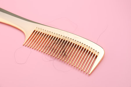 Comb with lost hair on pink backgroundの写真素材