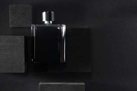 Stylish presentation of luxury men`s perfume in bottle on black background, top view. Space for textの写真素材