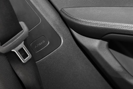 Safety belt and seat inside of modern black car, closeup