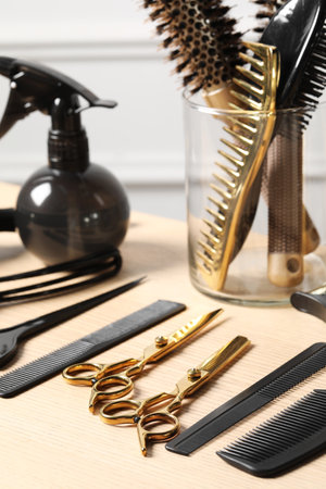 Hairdresser tools. Different scissors and combs on wooden table in salonの写真素材