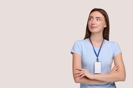 Woman with blank badge on grey background, space for textの写真素材
