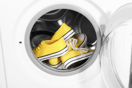 Stylish clean sneakers inside modern washing machineの写真素材