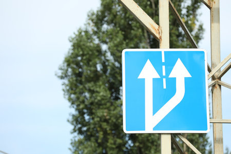 Additional lane on right begins road sign outdoorsの写真素材