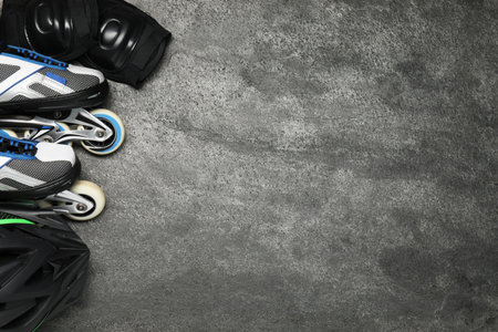 Different sports equipment on gray textured table, flat lay. Space for text
