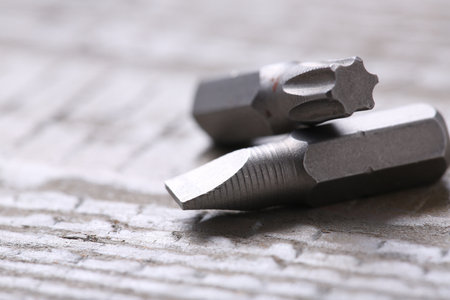 Different screwdriver bits on wooden table, closeupの写真素材