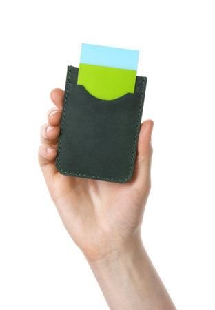 Woman holding leather business card holder with colorful cards on white background, closeupの写真素材