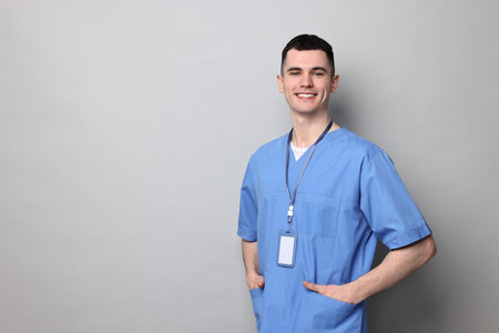 Portrait of smiling medical assistant on grey background. Space for textの写真素材