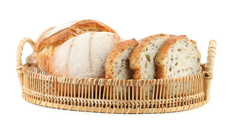 Wicker basket with different types of fresh bread isolated on whiteの写真素材
