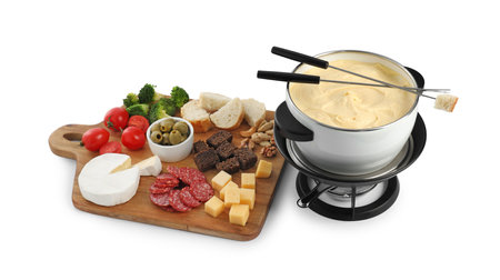 Fondue with tasty melted cheese, forks and different snacks isolated on whiteの写真素材