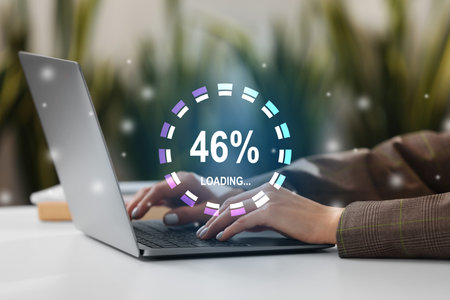 Loading progress. Woman working on laptop at table indoors, closeup