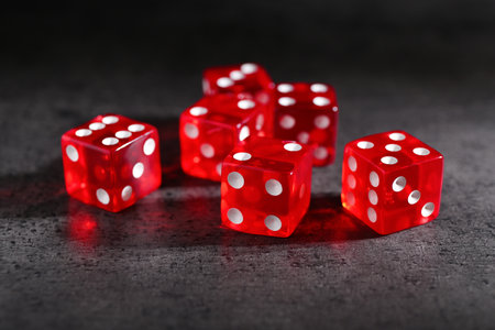 Many red game dices on gray textured table, closeupの写真素材