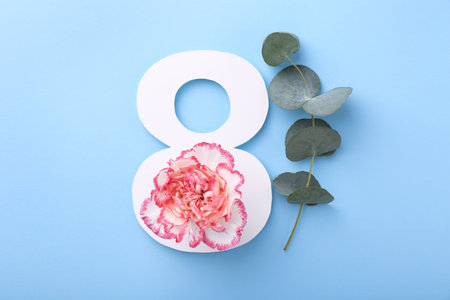 Paper number 8, beautiful flower and eucalyptus branch on light blue background, top view