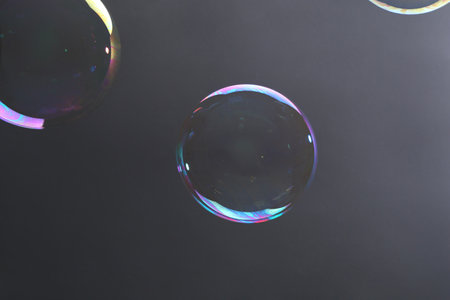 Beautiful transparent soap bubbles on gray backgroundの写真素材