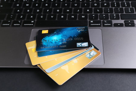 Laptop with credit cards on grey table