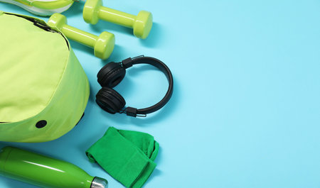 Different sports equipment on light blue background, flat lay. Space for text