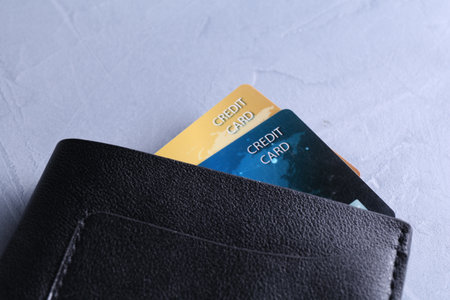 Credit cards in leather wallet on gray textured table, closeupの写真素材