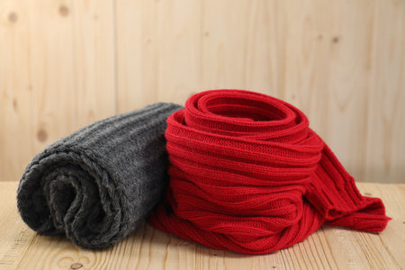 Red and gray knitted scarfs on wooden tableの写真素材