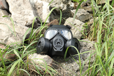 One gas mask on ground with stones outdoorsの写真素材