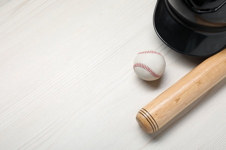 Sports equipment. Helmet, ball and baseball bat on white wooden table, flat lay. Space for textの写真素材
