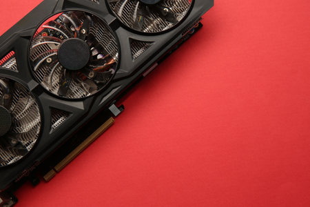 One graphics card on red background, top view. Space for text