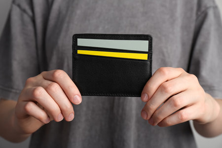 Woman holding leather business card holder with cards, closeupの写真素材