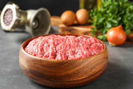 Raw ground meat in bowl on gray table, closeupの写真素材