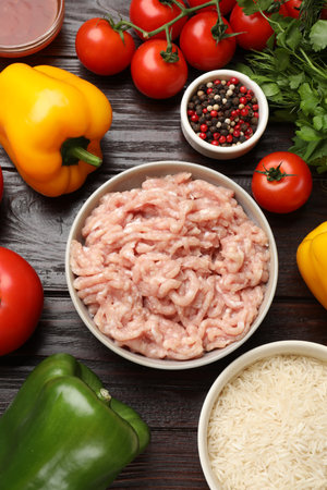 Making stuffed peppers. Ground meat and other ingredients on wooden table, flat layの写真素材