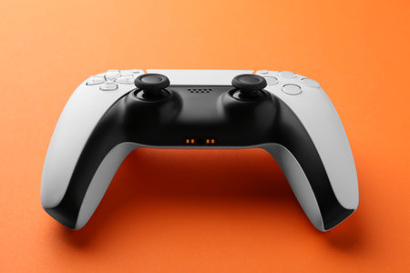 One wireless game controller on orange background