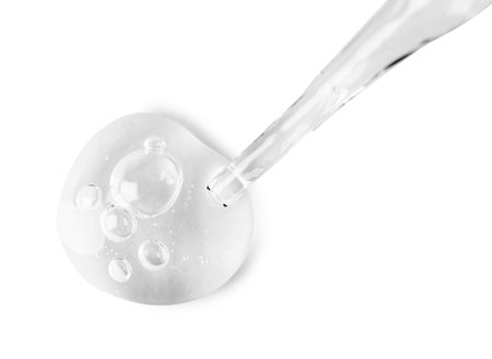 Glass pipette and transparent liquid isolated on white, top viewの写真素材