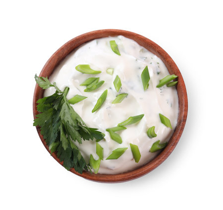 Delicious yogurt with green onion and parsley in bowl isolated on white, top viewの写真素材