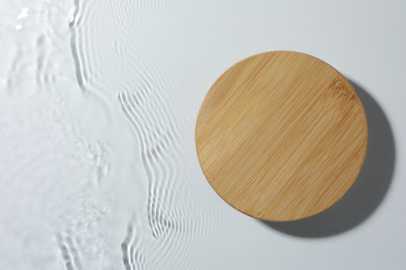Presentation of product. Wooden podium in water on white background, top view. Space for textの写真素材