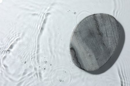 Presentation of product. Stone podium in water on white background, top view. Space for textの写真素材