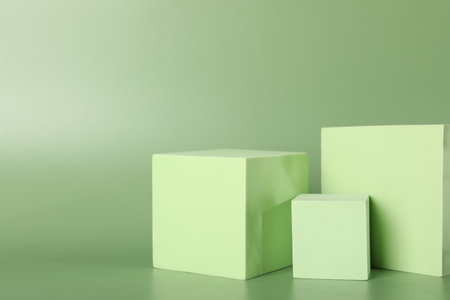 Presentation of product. Podiums and shadows on green background. Space for textの写真素材