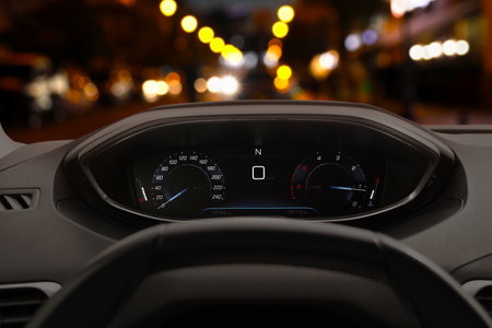 Dashboard with speedometer behind steering wheel inside carの写真素材