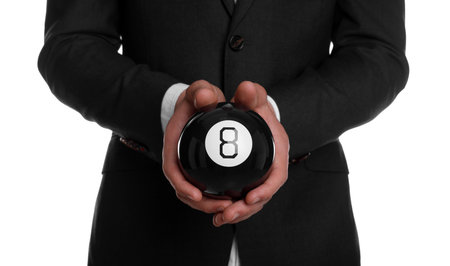 Man holding magic eight ball on white background, closeup