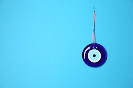 Evil eye amulet on light blue background, top view. Space for textの写真素材