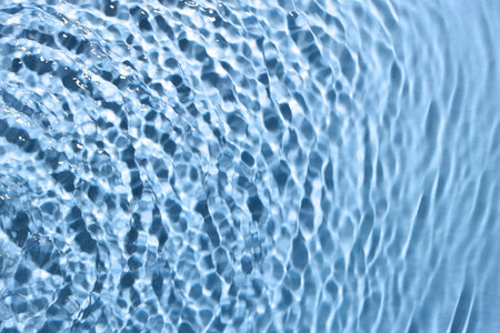Rippled surface of clear water on light blue background, top viewの写真素材