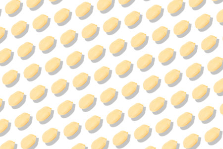 Pattern of peeled peanuts on white background