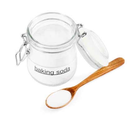 Baking soda in jar and spoon isolated on whiteの写真素材