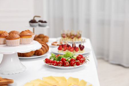 Different meals served on white table indoors. Buffet menuの写真素材