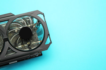 One graphics card on light blue background, top view. Space for text