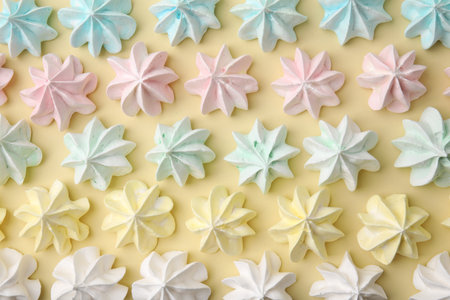 Delicious meringue cookies on beige background, flat layの写真素材